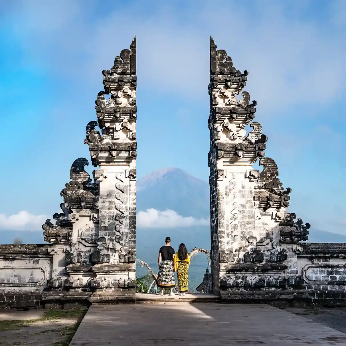Couple in the Lempuyang temple gate with Mount Agung behind
