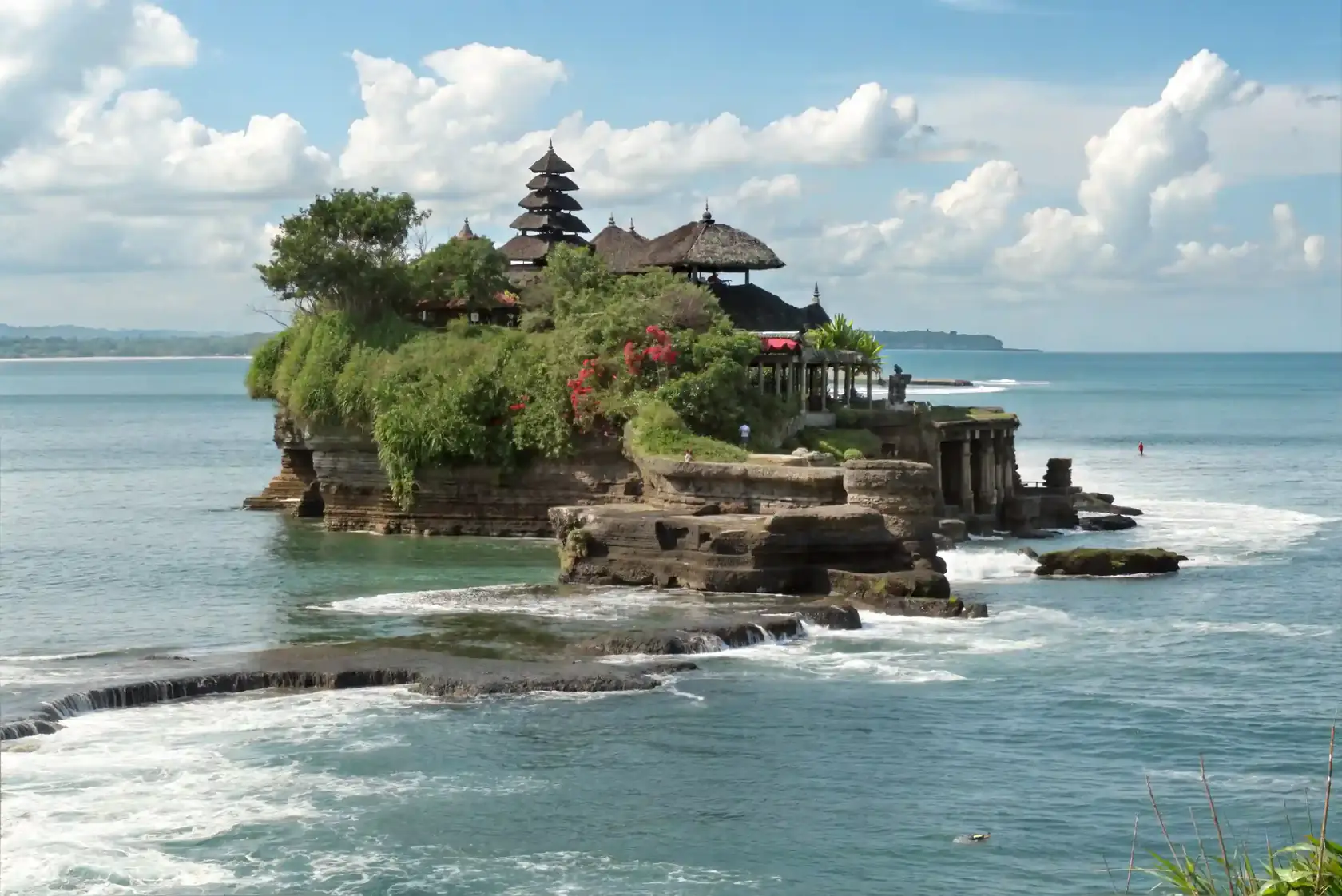 Tanah Lot temple on its rock with sea and clouds