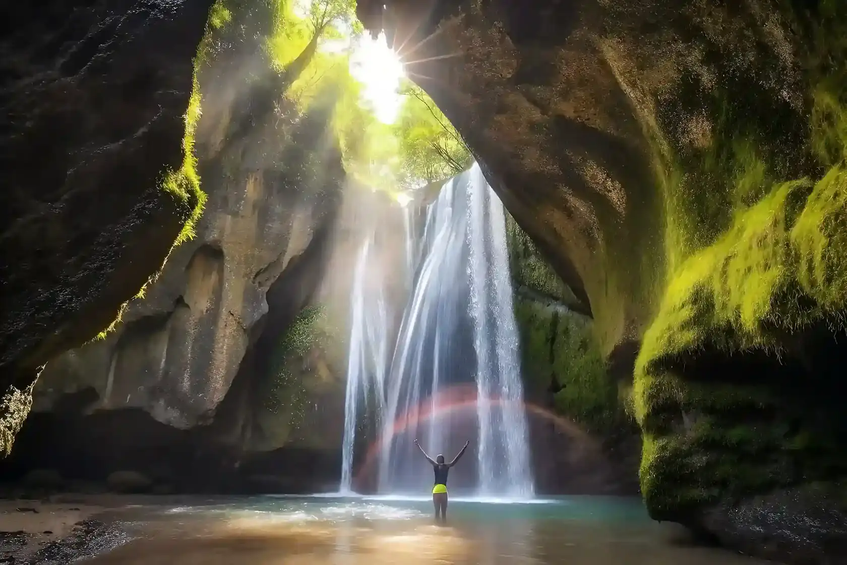 Tukad Cepung waterfall inside a cave with beams of light