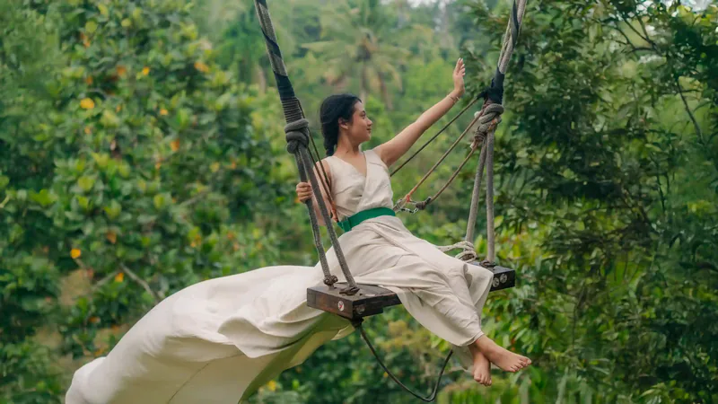 Traveller on a jungle swing near Ubud